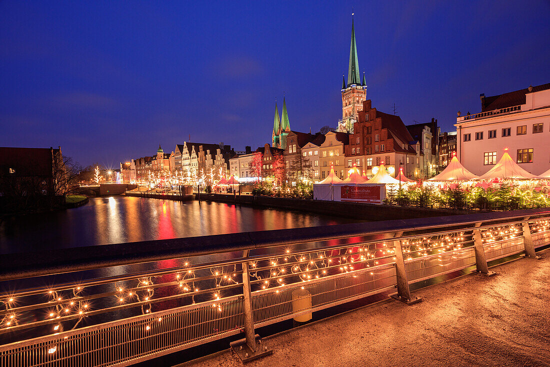 Night view of typical houses and the cathedral reflected in river Trave Lübeck Schleswig Holstein Germany Europe