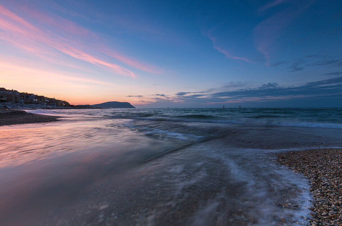 Waves crashing on the beach framed by the blue dusk Porto Recanati Province of Macerata Conero Riviera Marche Italy Europe