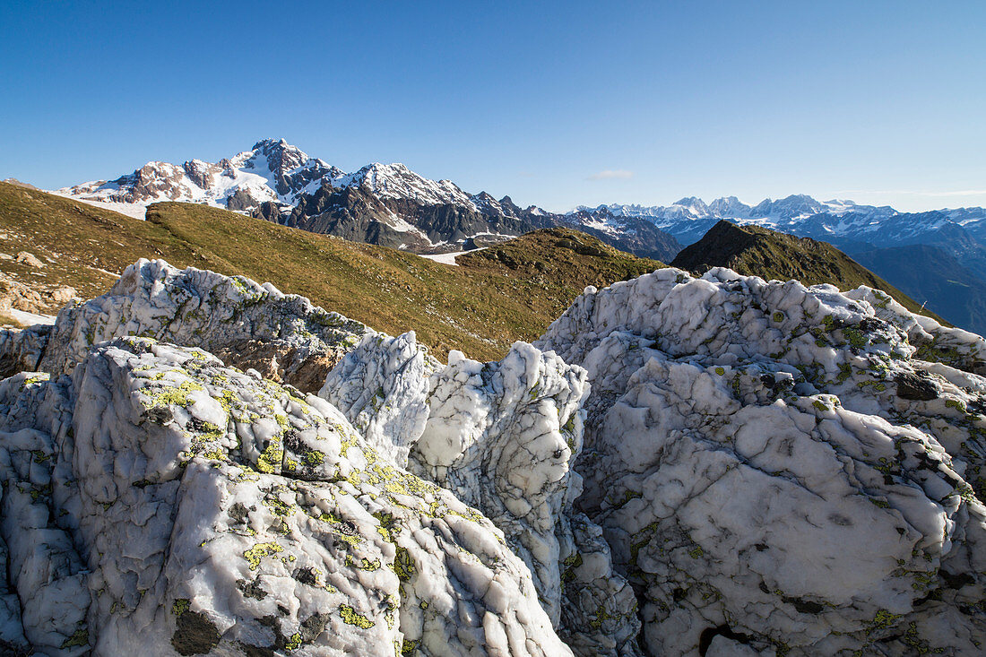 Sasso Bianco frames the snowy peak of Mount Disgrazia Malenco Valley Valtellina Province of Sondrio Lombardy Italy Europe