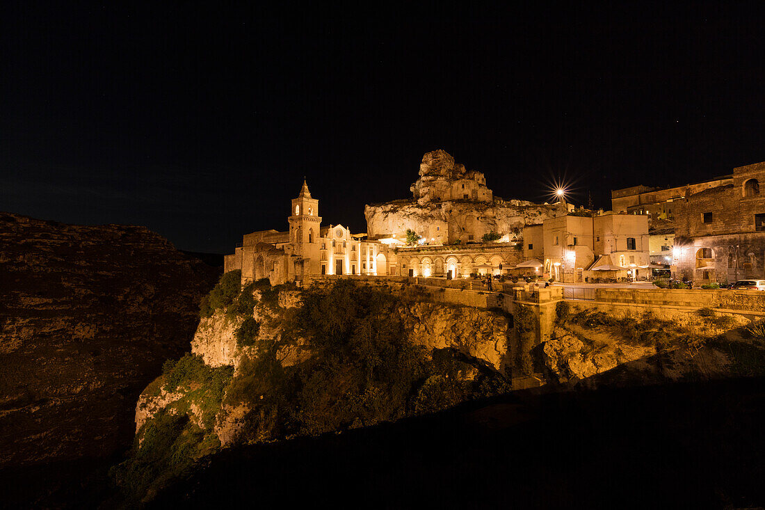 Night view of ancient town and historical center called Sassi perched on rocks on top of hill Matera Basilicata Italy Europe