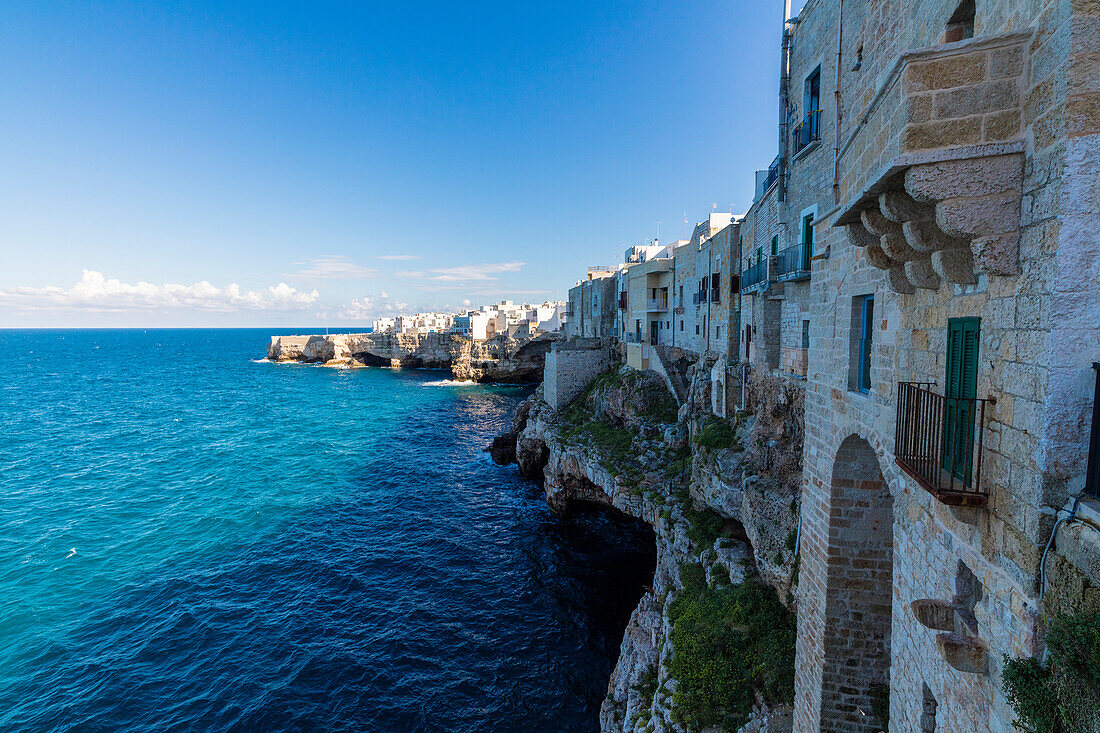 Blue sea framed by the old town perched on the rocks Polignano a Mare province of Bari Apulia Italy Europe