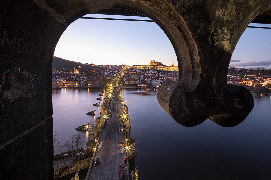 Vltava , Moldava  river framed by Charles Bridge at dusk Prague Czech Republic Europe