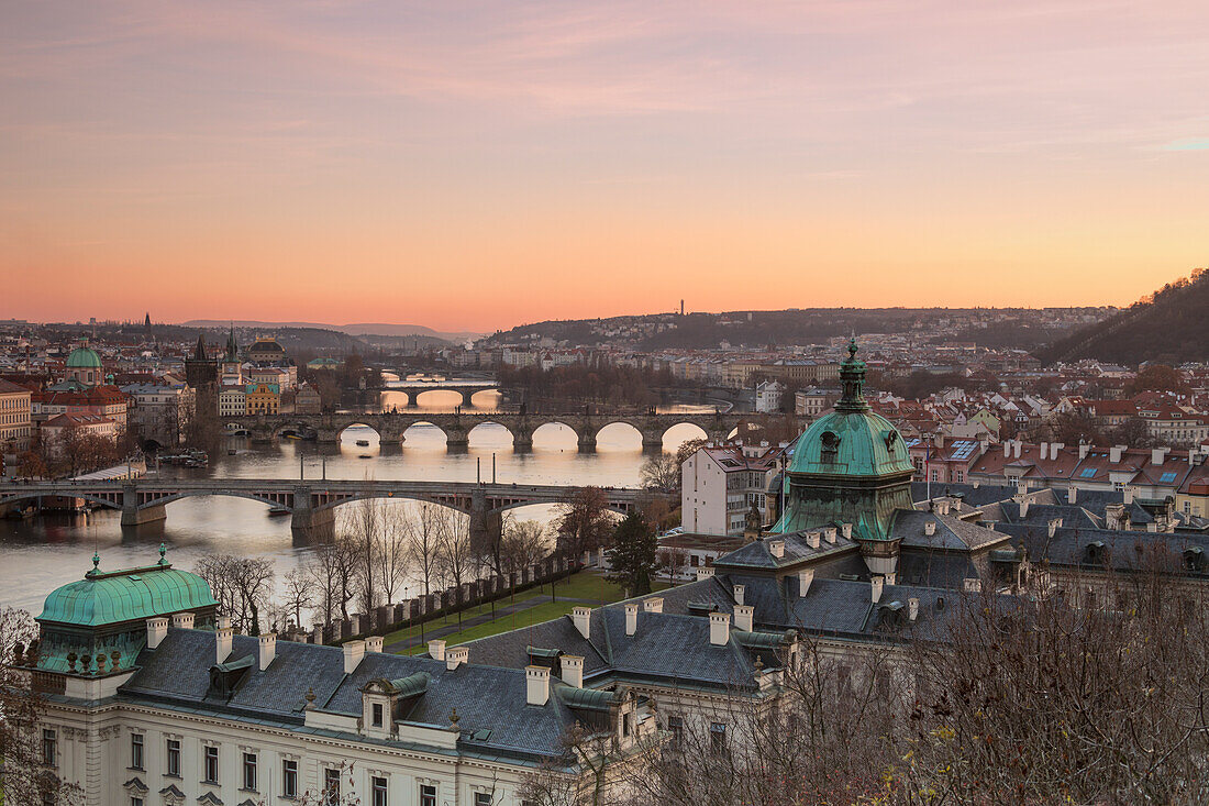 Rosa Himmel auf historischen Brücken und Gebäuden spiegelt sich auf Moldau, Moldava Fluss bei Sonnenuntergang Prag Tschechische Republik Europa
