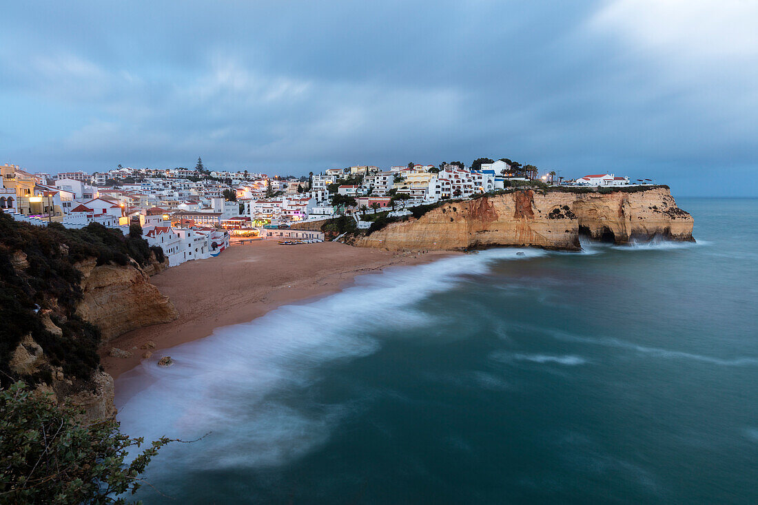 View of Carvoeiro village surrounded by sandy beach and clear sea at dusk Lagoa Municipality Algarve Portugal Europe