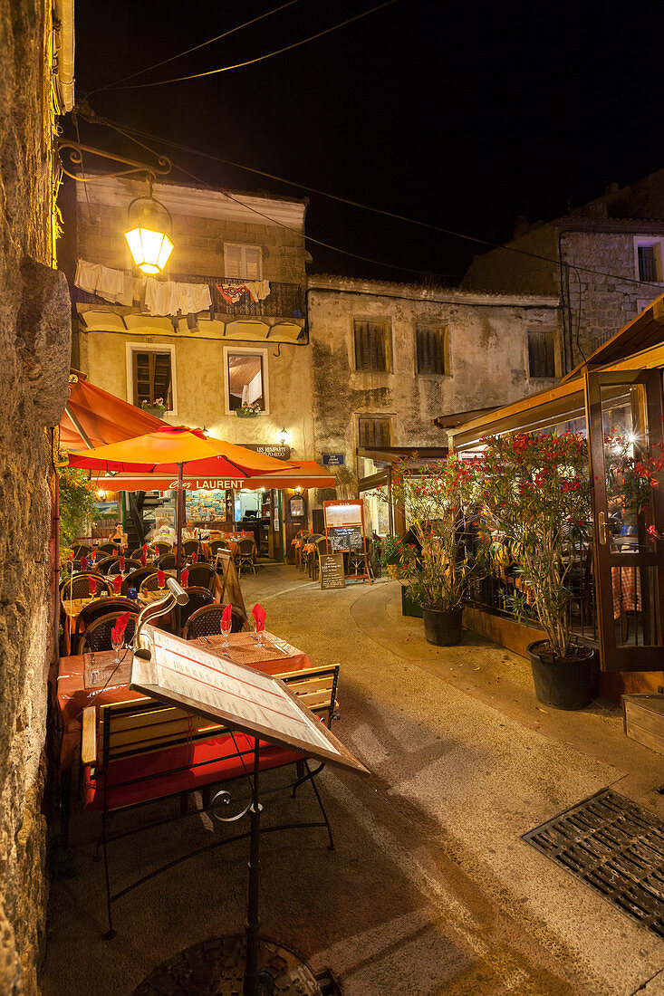 Night view of the typical alleys and restaurants of the old town Porto Vecchio Corsica France Europe