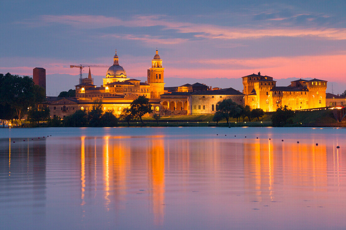 Mantova cityscape reflected in Mincio river at dusk, Mantova city, Mantova province, Lombardy district, Italy, Europe