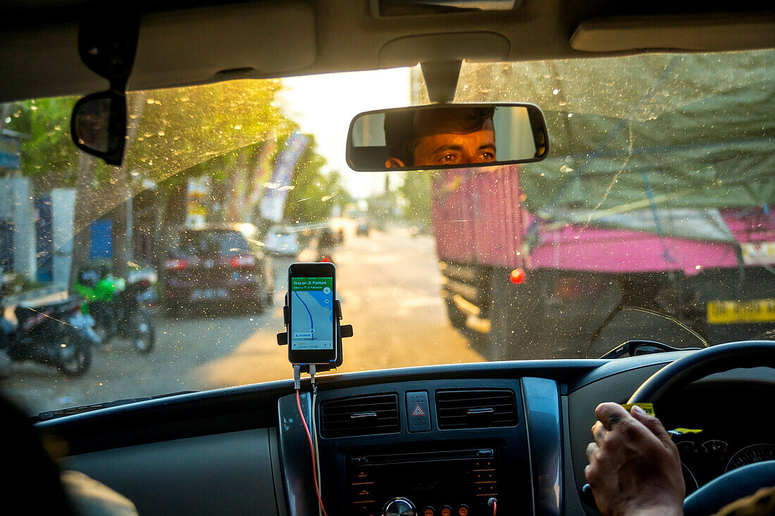 A Mobilephone With GPS Apps In Car To Navigate Around Jakarta
