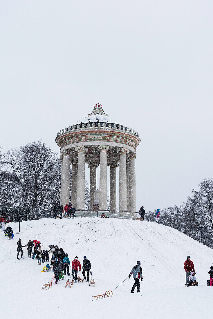 Schlittenfahren im Schneefall, Monopteros, Englischer Garten, München, Deutschland