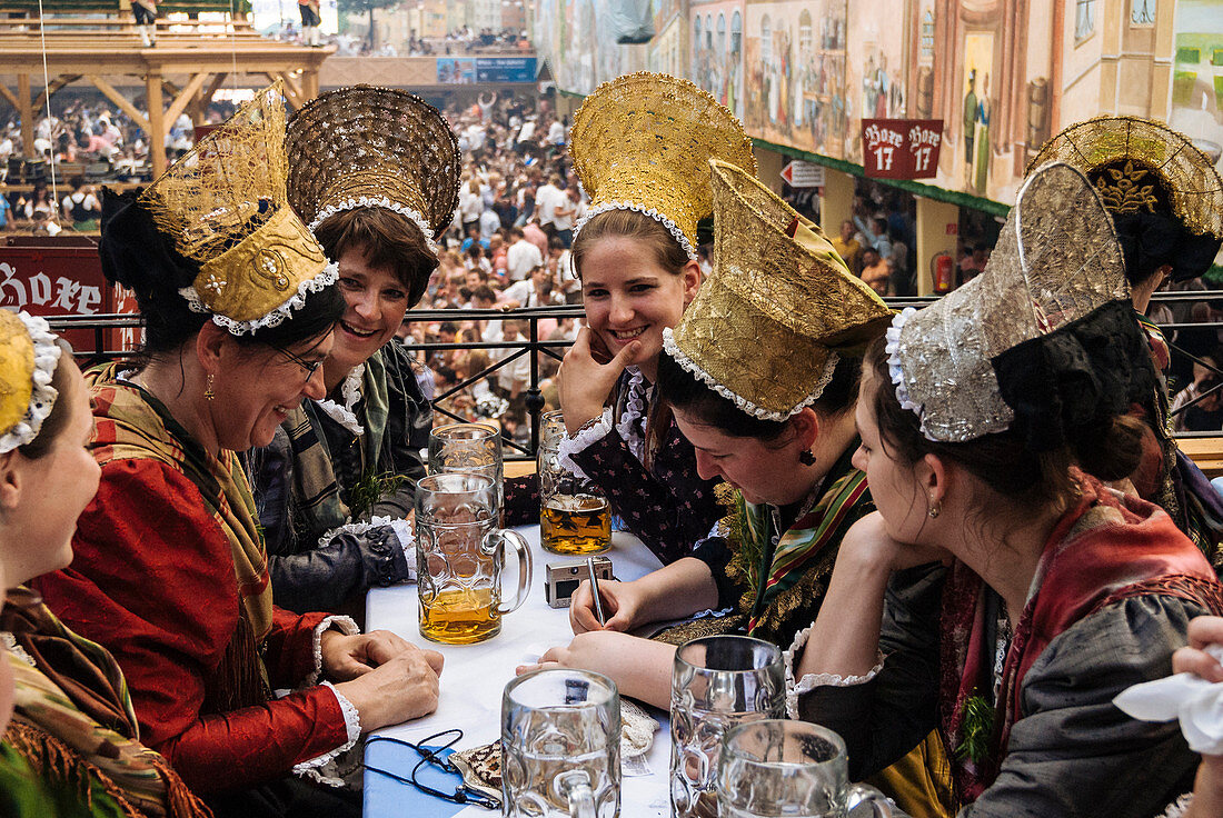 Women wearing the traditional golden hats, Oktoberfest, Munich, Bavaria, Germany