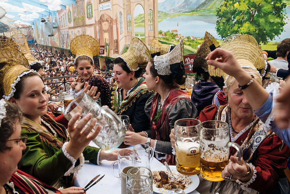 Women wearing the traditional golden hats, Oktoberfest, Munich, Bavaria, Germany