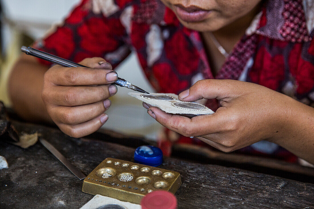An Indonesian woman makes silver jewelry by hand in her studio in Ubud, Bali.