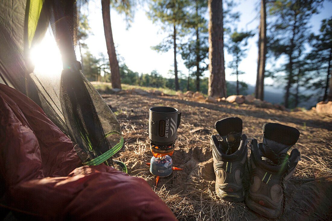 Camp Stove And Hiking Boot Are Placed Outside The Tent