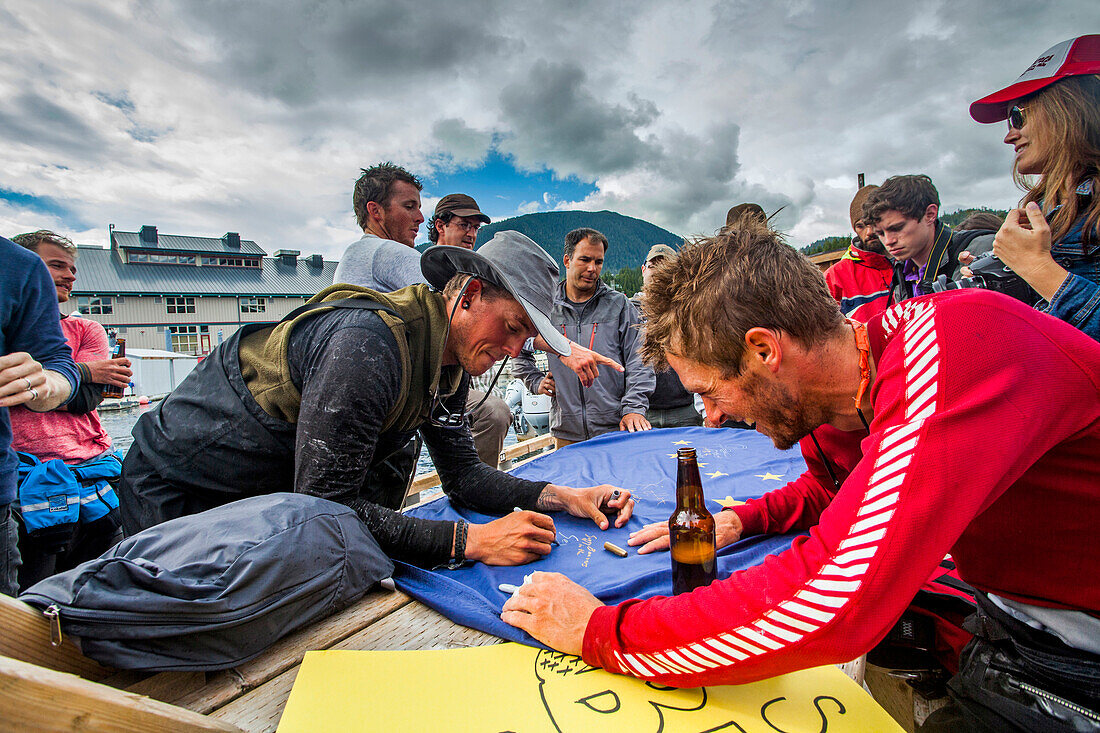 Team Members Enjoying On Dock During The Race To Alaska