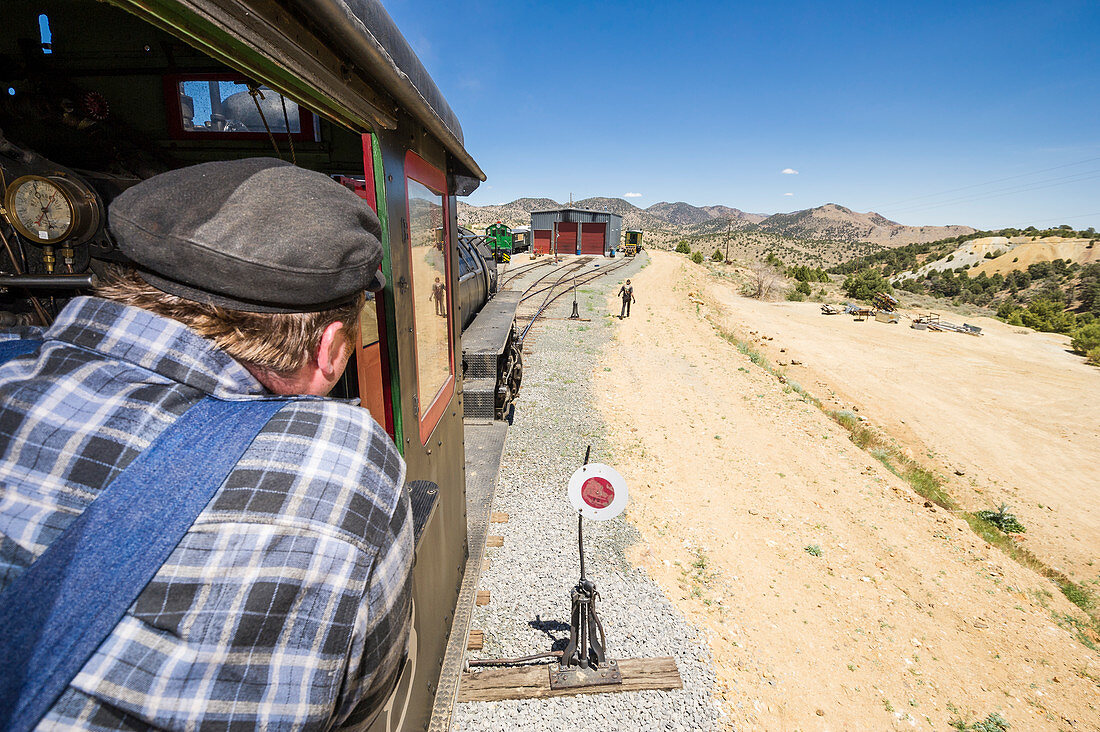 Steam train Engineer Brian Covey looks on as he drives train toward  engine house.  Virgina & Truckee Railroad