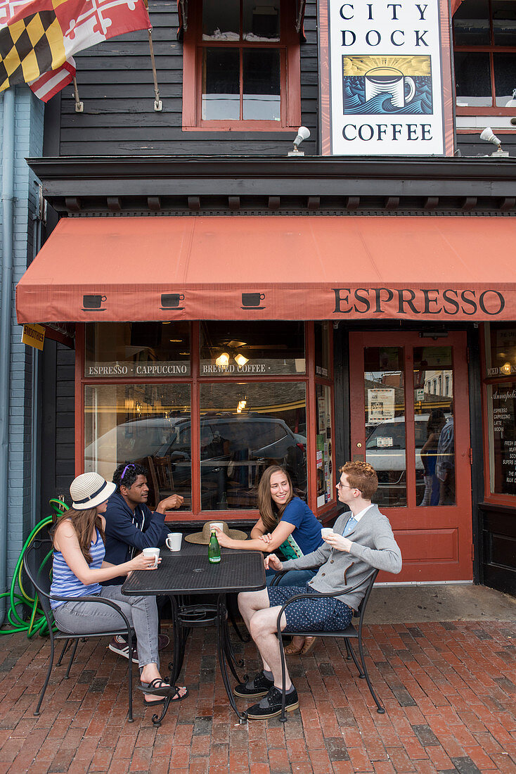 Friends socialize over coffee outside a cafe in Annapolis, Maryland.