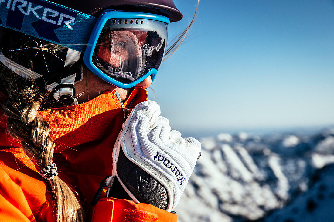 A woman preparing to ski in the early morning light of Snowbird, Utah.