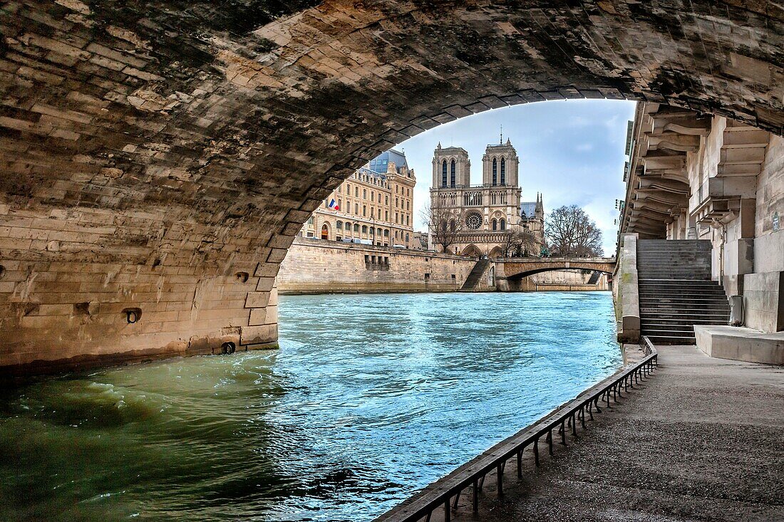 Notre Dame Cathedral view from under the bridge Saint Michel, River Seine and the Prefecture of Police, Paris, France