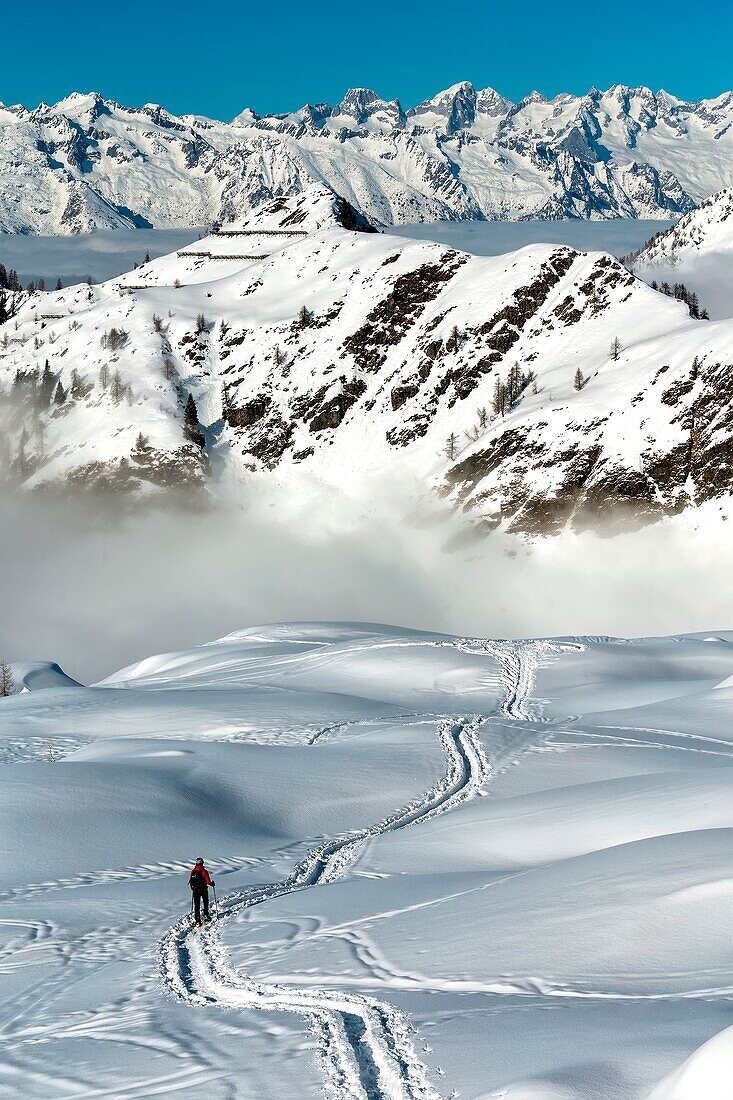 Hiker Trekking through the thick snow in the Val Gerola Alps, Lombardia, Italy