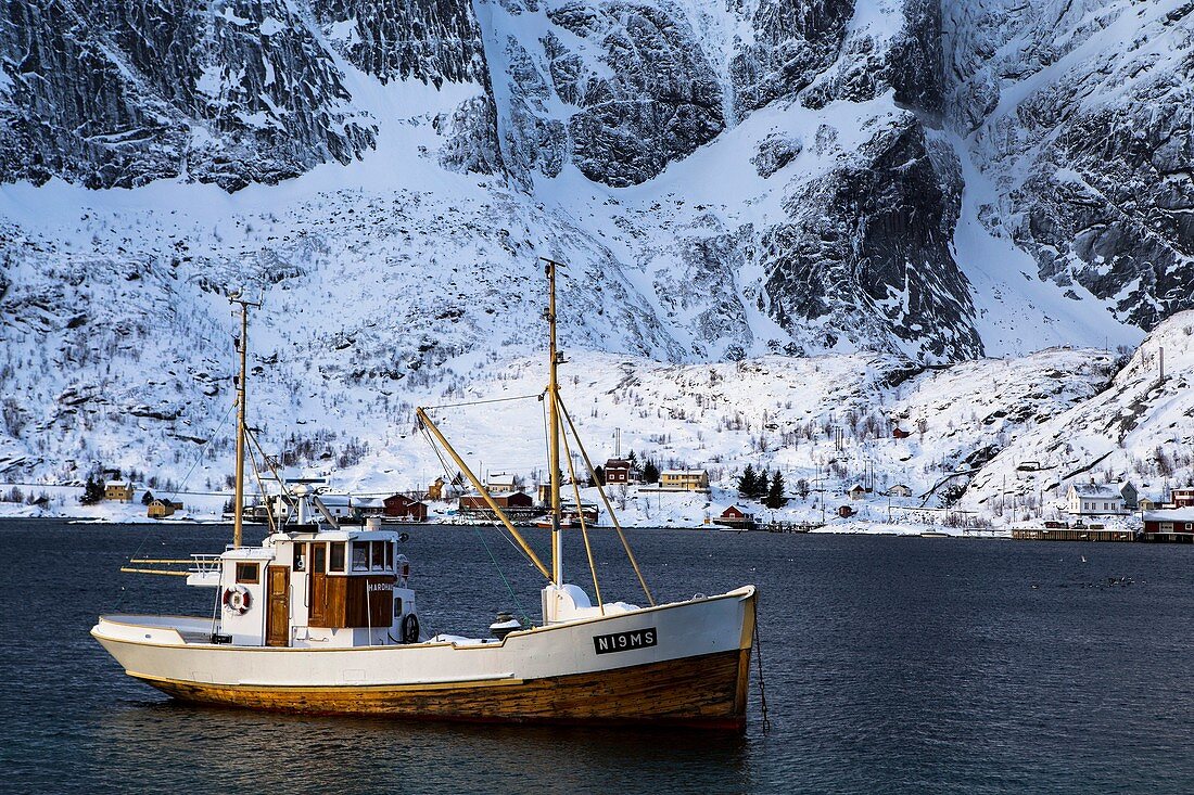 Norwegian fishing boat sailing through the seas of the Lofoten islands , Moskenes, Norway
