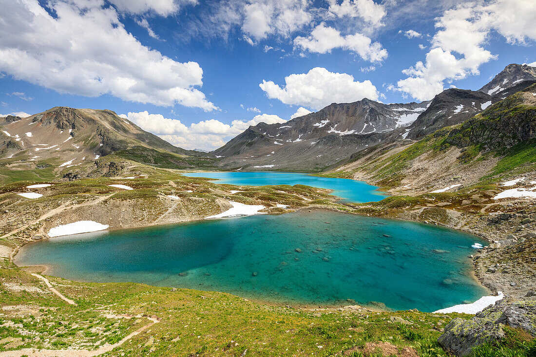 Clouds and sun on turquoise lakes framed by rocky peaks, Joriseen, Jorifless Pass, canton of Graubunden, Engadine, Switzerland, Europe