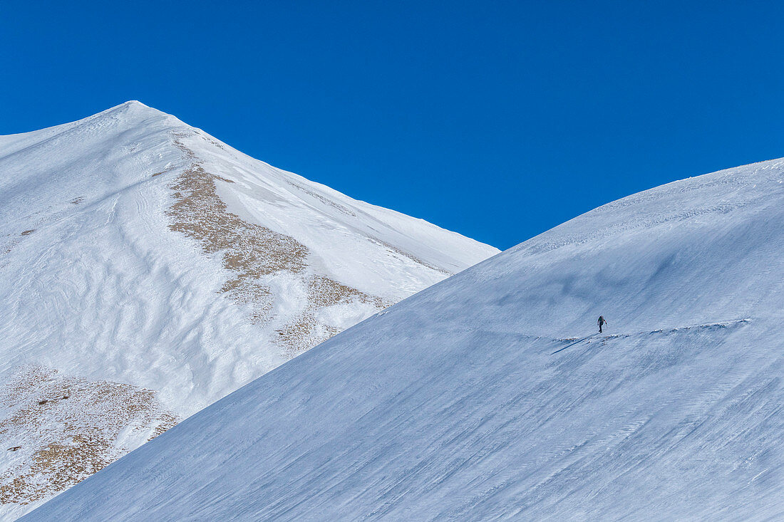 Hiker on mountain Vettore in winter, Sibillini National Park, Umbria, Italy, Europe