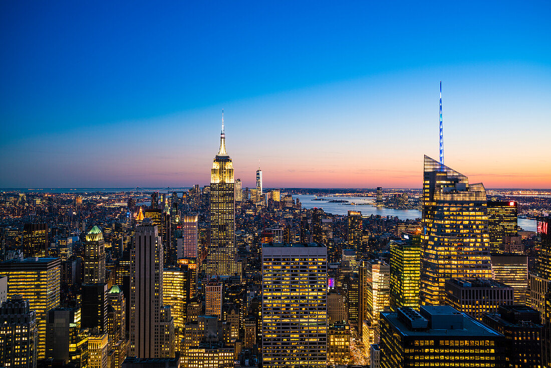 Manhattan skyline and Empire State Building at dusk, New York City, United States of America, North America