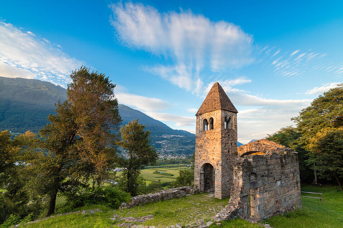 Sunset sky frames the ancient Abbey of San Pietro in Vallate, Piagno, Sondrio province, Lower Valtellina, Lombardy, Italy, Europe