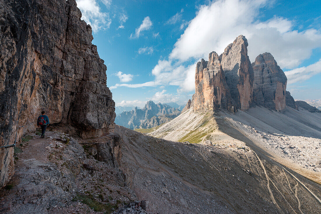 Europe, Italy, Dolomites, Veneto, Belluno, Hiker admire Tre Cime di Lavaredo from Trenches of the First World War on Mount Paterno