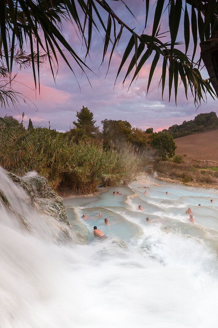 Tourists relaxing during sunset at termal Waterfall Mill of Saturnia, Waterfall Mill, Cascata del Mulino, Saturnia, Manciano, Grosseto province, Tuscany, Italy, Europe