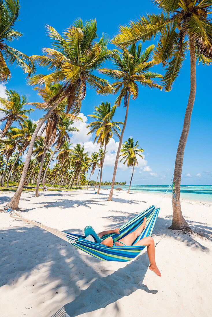 Canto de la Playa, Saona Island, East National Park , Parque Nacional del Este, Dominican Republic, Caribbean Sea, Woman relaxing on a hammock on the beach , MR