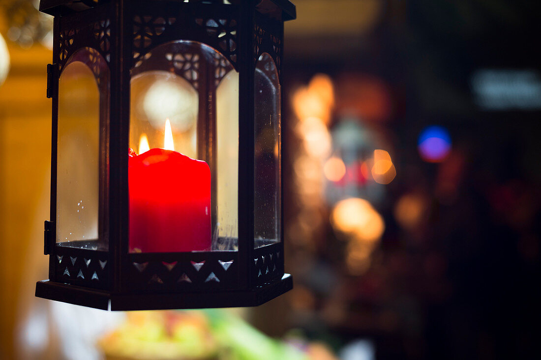a close up image of a red candle during the Christmas market in the village of Klausen, Bolzano province, South Tyrol, Trentino Alto Adige, Italy, Europe