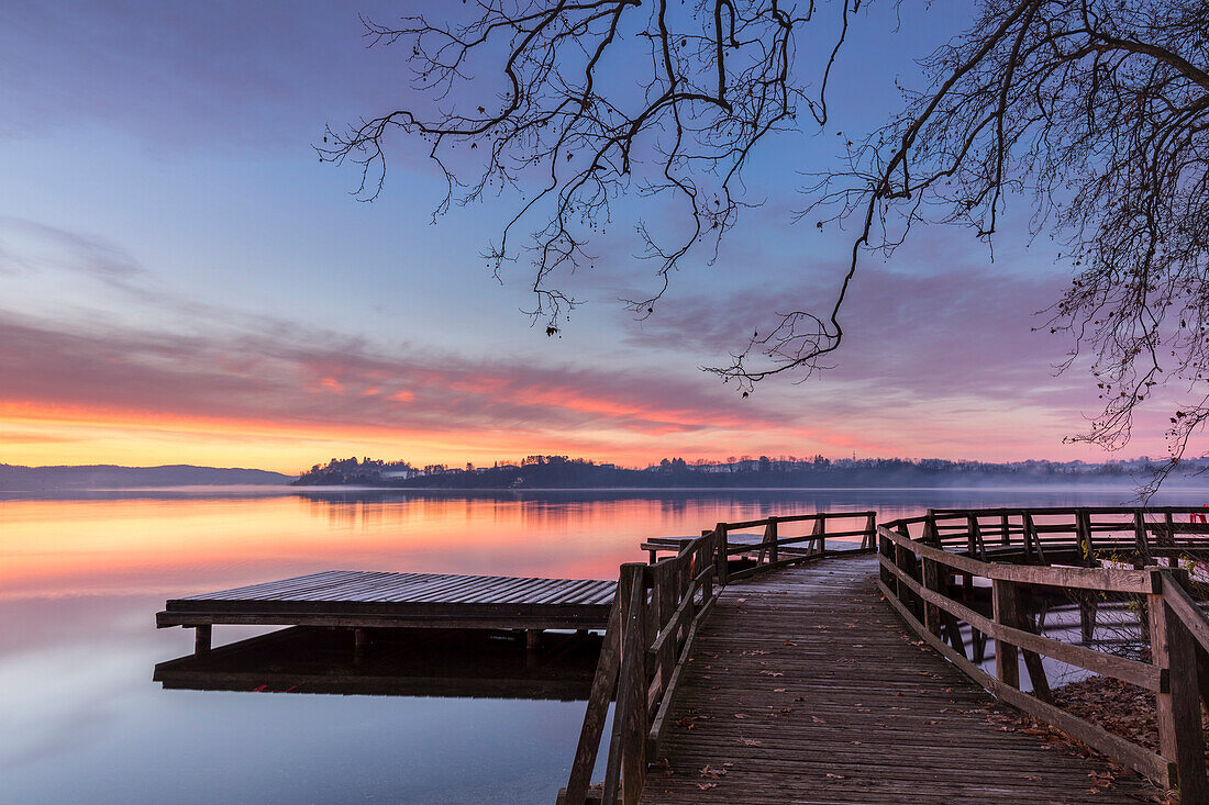 Winter sunrise on the Gavirate pier of Lago di Varese, Varese Province, Lombardy, Italy