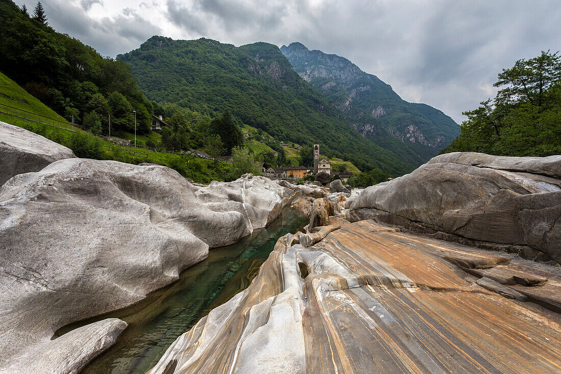 The rocks on the bed of river Verzasca and the church of Lavertezzo, Valle Verzasca, Canton Ticino, Switzerland