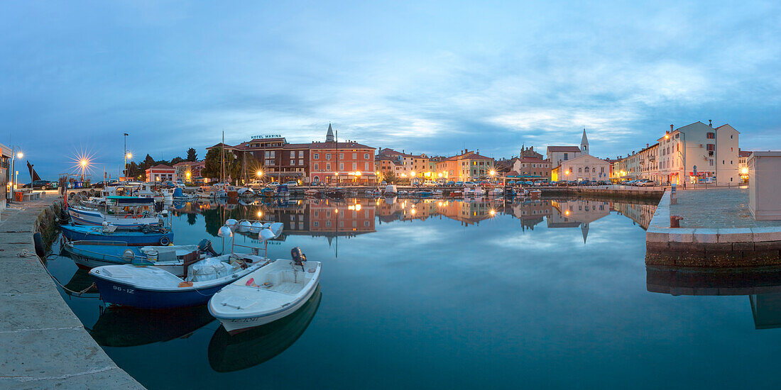 Europe, Slovenia, Primorska, Izola, Old town and the harbour with fishing boats at dusk