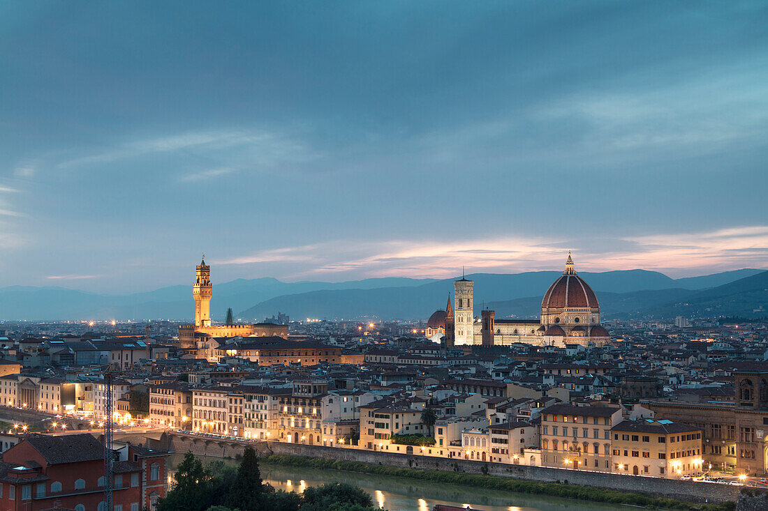 The blue light of dusk frames the city of Florence crossed by Arno River seen from Piazzale Michelangelo Tuscany Italy Europe