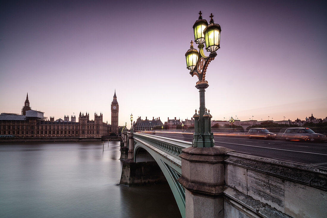 Old street lamp frames Westminster Bridge with Big Ben and Westminster Palace in the background London United Kingdom