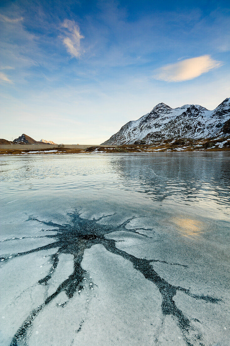 Sunset on the frozen Lej Nair surrounded by snowy peaks Bernina Pass Canton of Graubünden Engadine Switzerland Europe