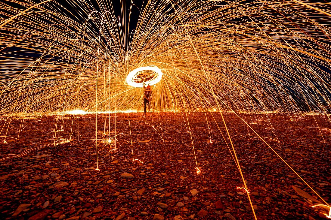 man who practices the technique of steelwool, piacenza, emilia romagna, italy