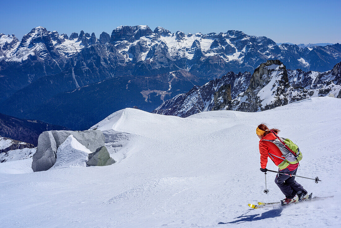 Woman backcountry skiing descending from Cima Presanella, Presanella, Adamello group, Trentino, Italy