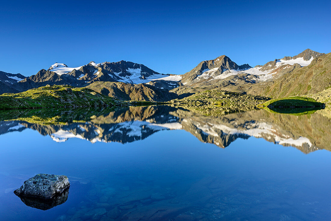Stubai Alps with Wilder Pfaff, Zuckerhuetl, Aperer Pfarr, Schaufelspitze and Stubaier Wildspitze reflecting in mountain lake, lake Mutterberger See, Stubai highroute, Stubai Alps, Tyrol, Austria
