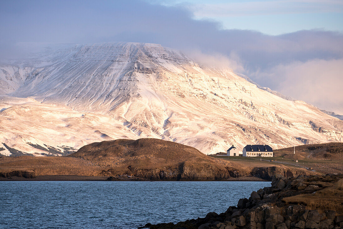Snowy landscape at the coast of Reykjavik with the mountain Esja in clouds, near Reykjavik, Iceland, Europe