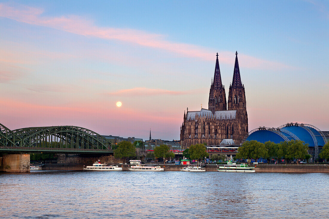 Full moon, view over the Rhine river to Hohenzollern bridge, Cologne cathedral and musical dome, Cologne, North Rhine-Westphalia, Germany