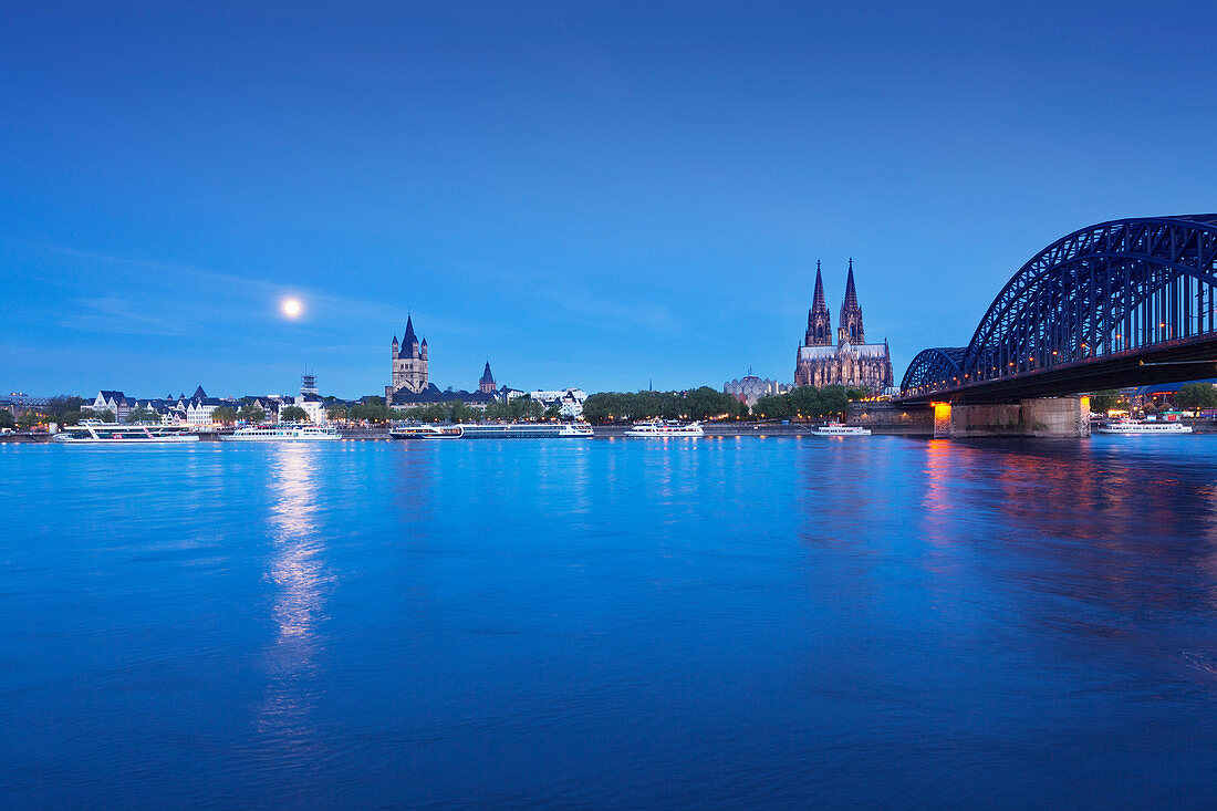 Full moon, view over the Rhine river to the Old town with Gross-St-Martin, Cologne Cathedral, Museum Ludwig, cathedral and Hohenzollern bridge, Cologne, North Rhine-Westphalia, Germany