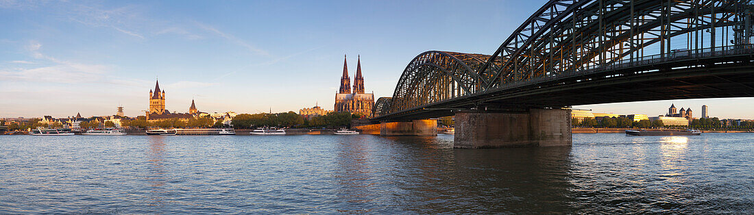 Panoramic view over the Rhine river to the Old town with Gross-St. Martin, Museum Ludwig, cathedral and Hohenzollern bridge, Cologne, North Rhine-Westphalia, Germany
