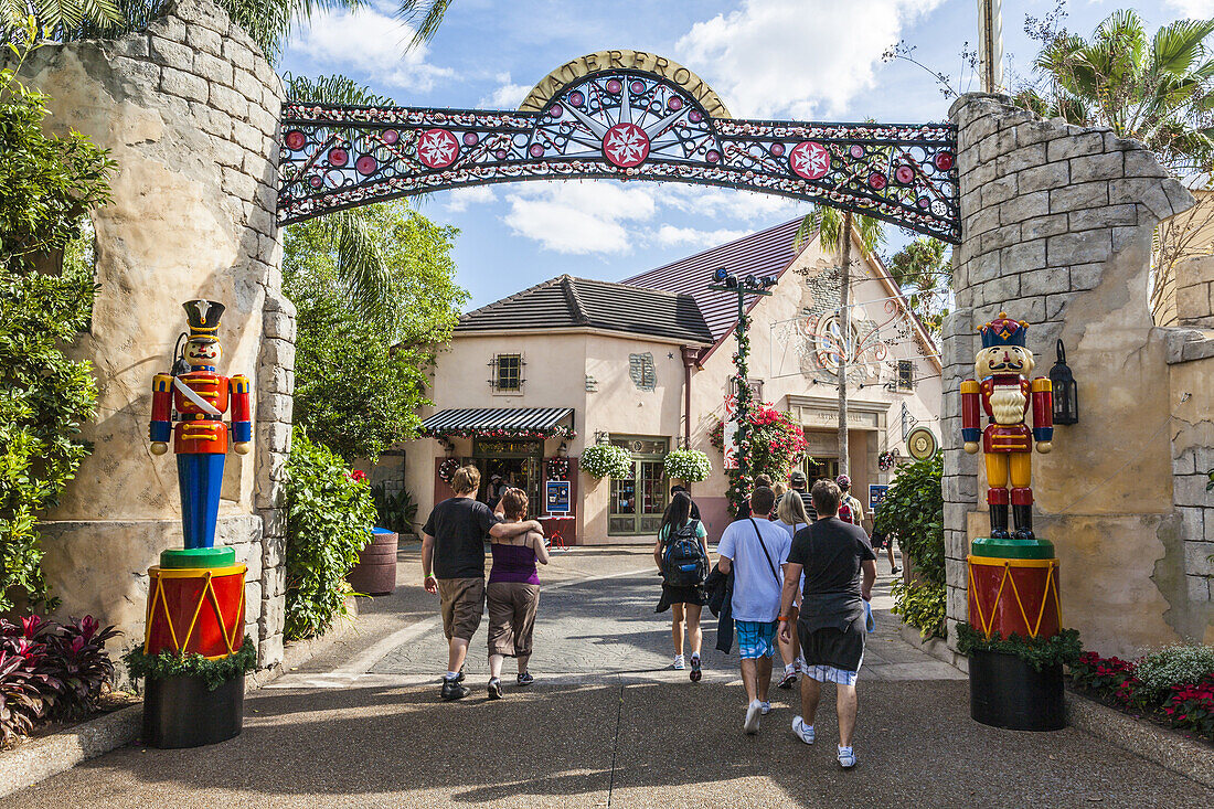 Young people walking under arch and past toy soldiers at the entrance to the Waterfront area of SeaWorld, Orlando, FL.,X2I-2166897 - © - Ron Buskirk