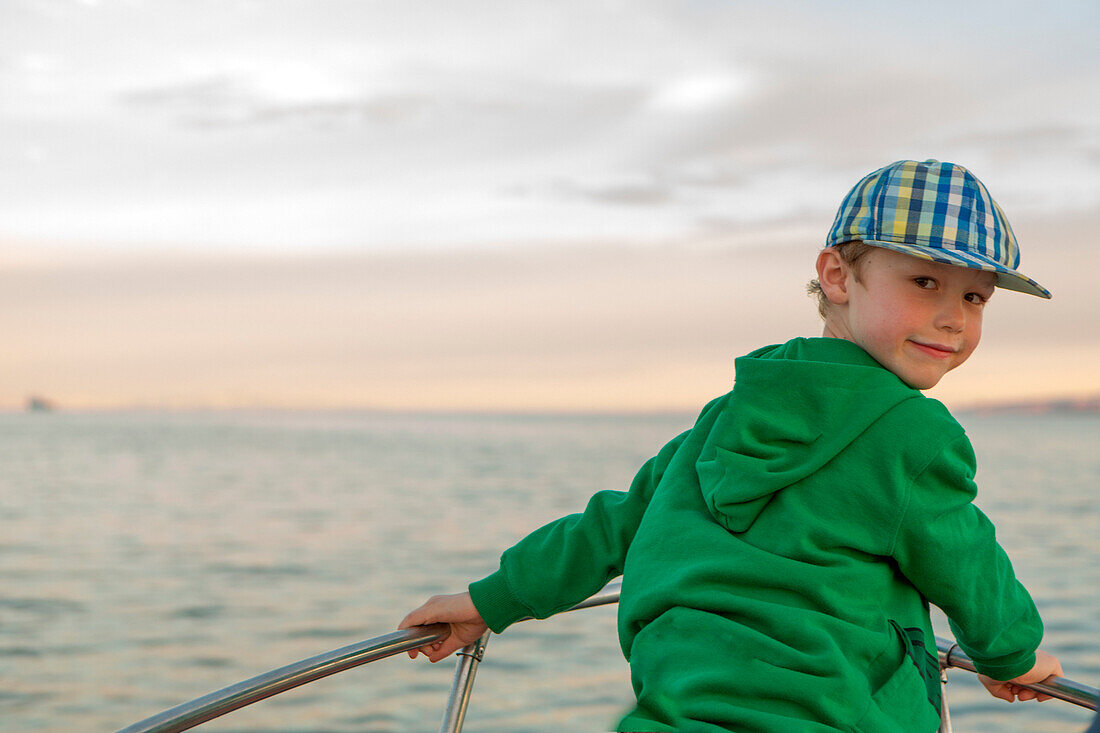 Portrait of young boy on prow of boat