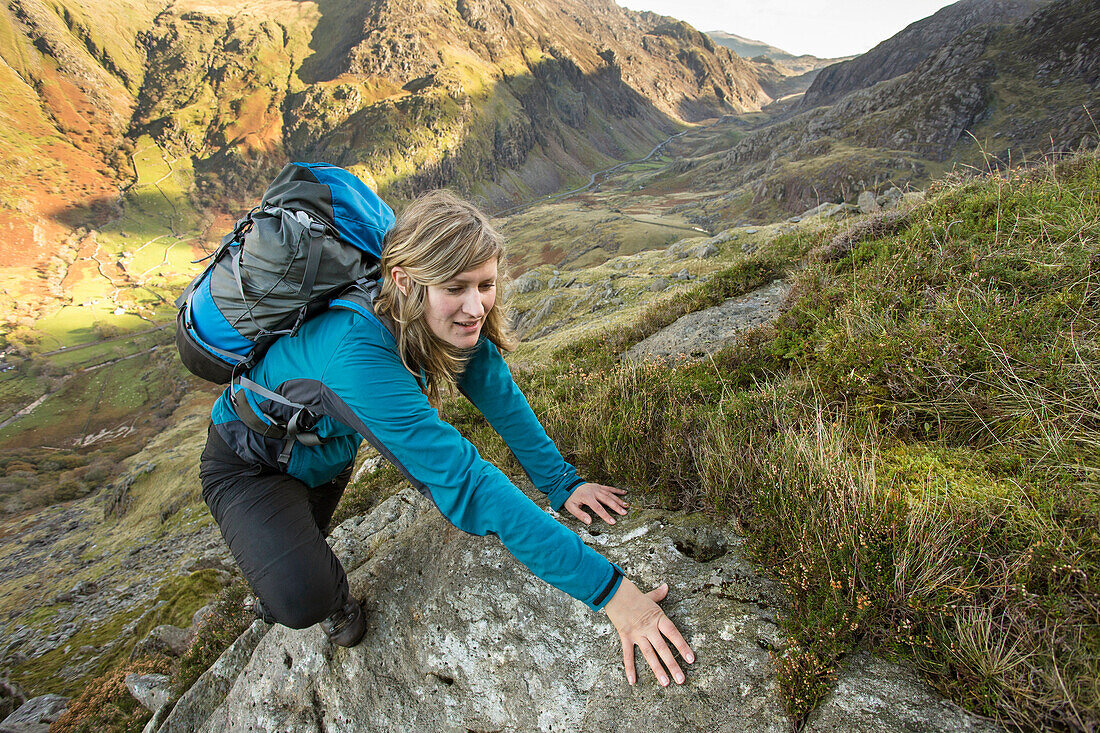 Female hiker arrives at mountain summit