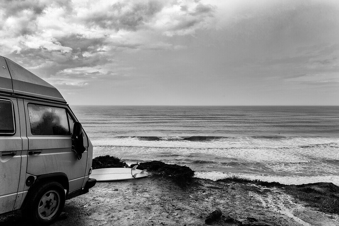 Surfer Campervan In Front Of The Breaking Waves At Ponta Ruiva Beach, Algarve, Portugal
