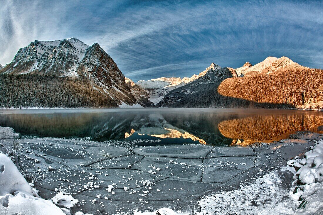 Reflection of mountains in icy lake, winter