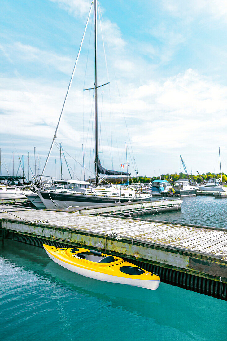 Yellow kayak moored in dock